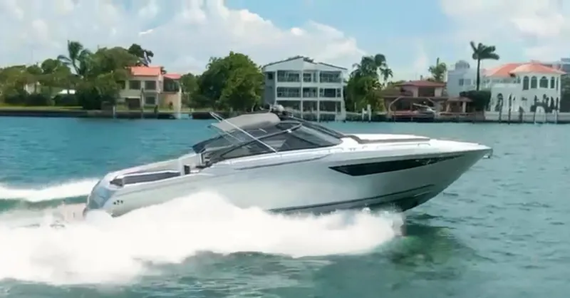  Yacht Photos Pics 2007 Baia BAIA ONE 43 yacht cruising on a sunny day near waterfront homes.