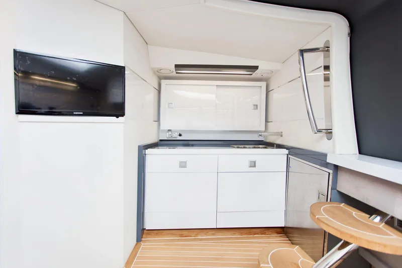  Yacht Photos Pics Modern interior of 2007 Baia BAIA ONE 43 yacht with sleek kitchen and mounted TV.