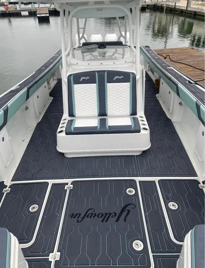  Yacht Photos Pics 2016 Yellowfin 39 boat interior with custom seating and flooring at a marina.