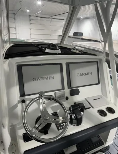  Yacht Photos Pics 2016 Yellowfin 39 boat dashboard with dual Garmin displays and steering wheel.