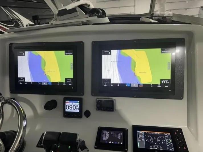  Yacht Photos Pics 2016 Yellowfin 39 boat dashboard with dual navigation screens and controls.