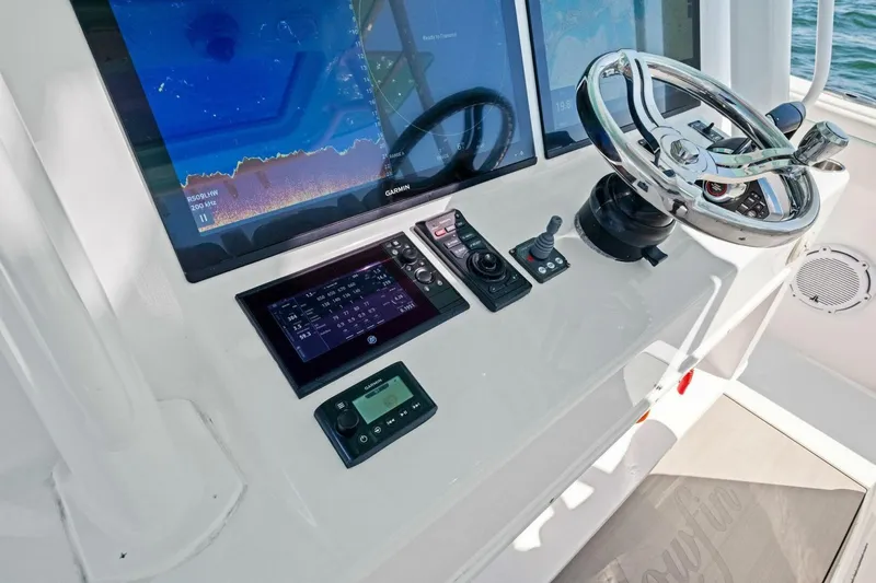 Midnight Rider Yacht Photos Pics Control panel of 2017 Yellowfin 42 Offshore boat with Garmin displays and steering wheel.