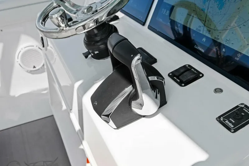 Midnight Rider Yacht Photos Pics Control panel of 2017 Yellowfin 42 Offshore boat with steering wheel and navigation screens.