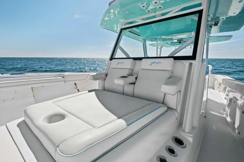 Midnight Rider Yacht Photos Pics 2017 Yellowfin 42 Offshore boat interior with cushioned seating, ocean view, and sleek design.