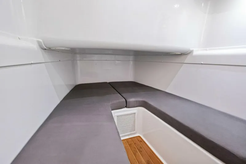 Midnight Rider Yacht Photos Pics 2017 Yellowfin 42 Offshore cabin interior with cushioned seating and wooden flooring.