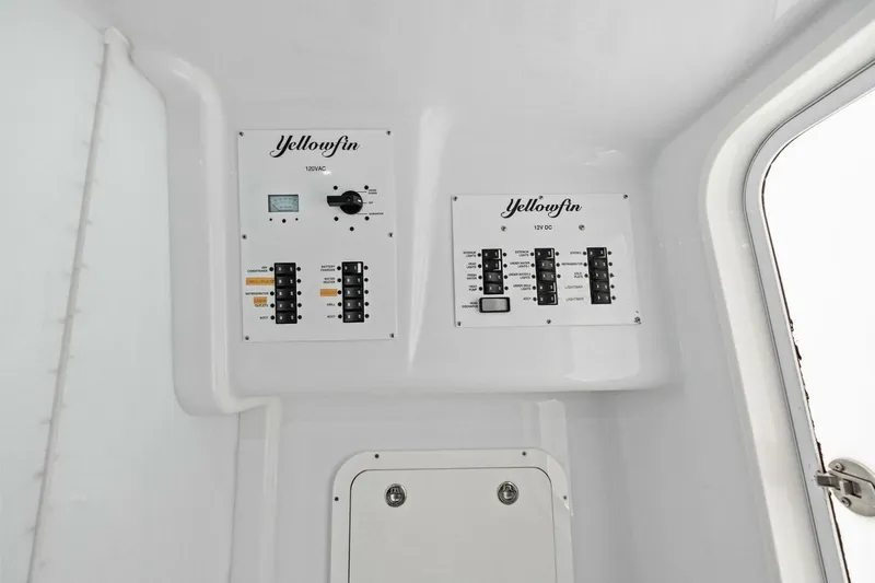 Midnight Rider Yacht Photos Pics Control panel of 2017 Yellowfin 42 Offshore boat, featuring 120VAC and 12VDC systems.