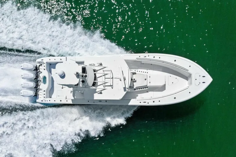 Midnight Rider Yacht Photos Pics 2017 Yellowfin 42 Offshore boat cruising on green water, aerial view.