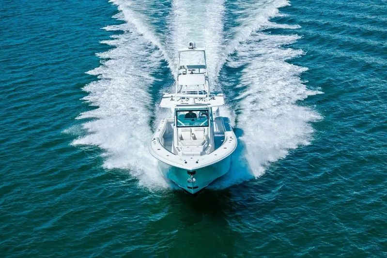 Midnight Rider Yacht Photos Pics 2017 Yellowfin 42 Offshore boat cruising on open water, creating a dynamic wake.