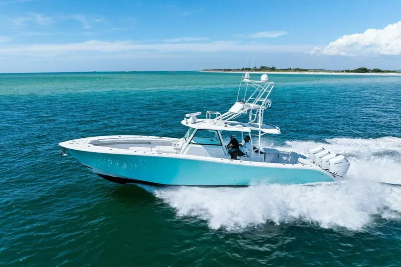 Midnight Rider Yacht Photos Pics 2017 Yellowfin 42 Offshore boat cruising on clear blue ocean waters.