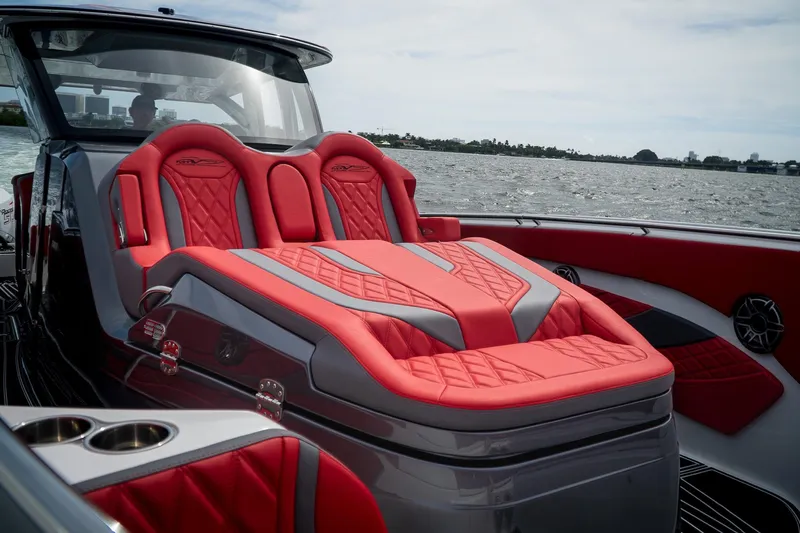  Yacht Photos Pics 2024 MTI V42 boat with luxurious red seating on open water.