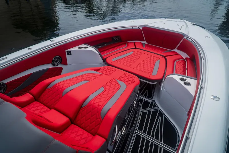  Yacht Photos Pics 2024 MTI V42 boat with luxurious red and gray seating, docked on water.