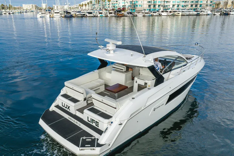 Lux Life Yacht Photos Pics 2017 Cruisers Yachts 39 Express Coupe on serene marina waters, showcasing luxury design.