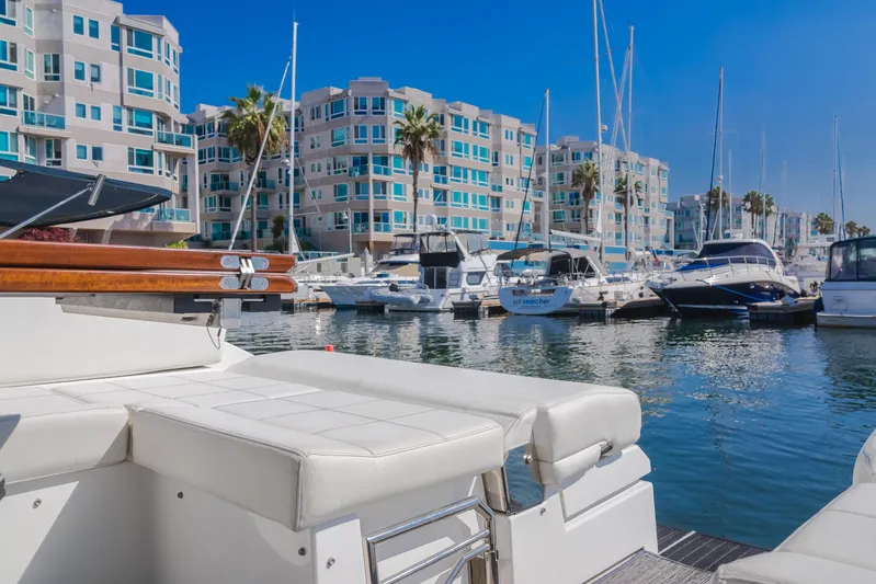 Lux Life Yacht Photos Pics 2017 Cruisers Yachts 39 Express Coupe docked in a marina with waterfront buildings.