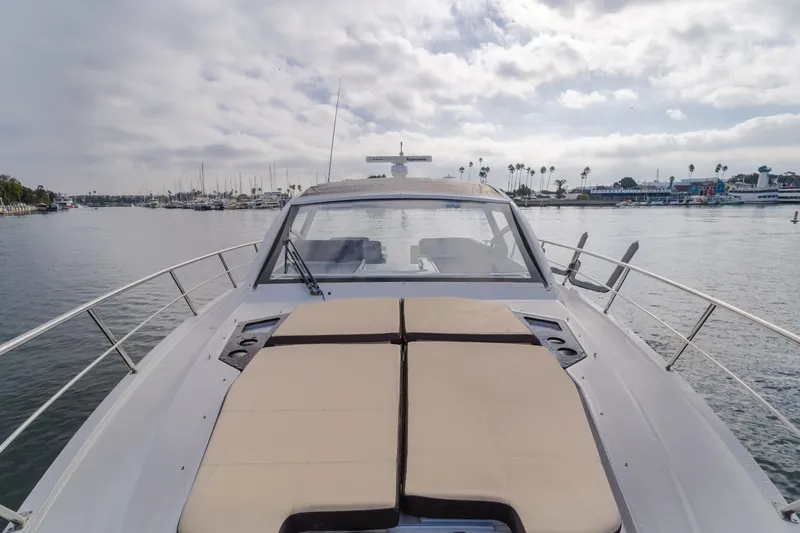 Lux Life Yacht Photos Pics 2017 Cruisers Yachts 39 Express Coupe on calm water, showcasing spacious deck and sleek design.