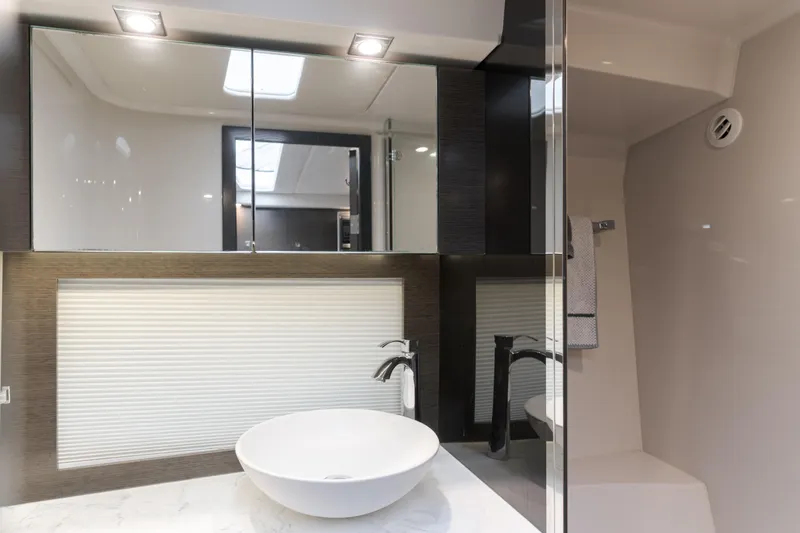 Lux Life Yacht Photos Pics Luxurious bathroom interior of 2017 Cruisers Yachts 39 Express Coupe with modern fixtures.