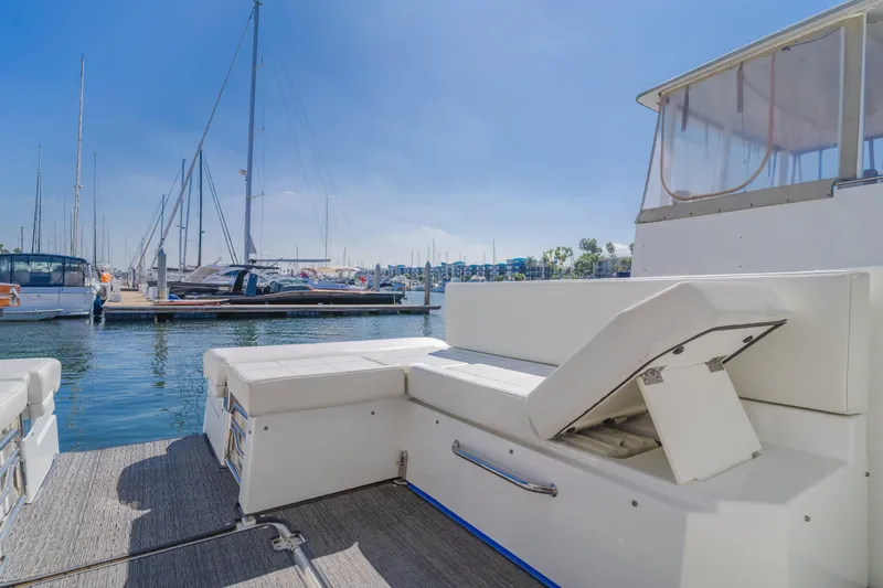 Lux Life Yacht Photos Pics 2017 Cruisers Yachts 39 Express Coupe at marina, featuring spacious seating and clear blue skies.