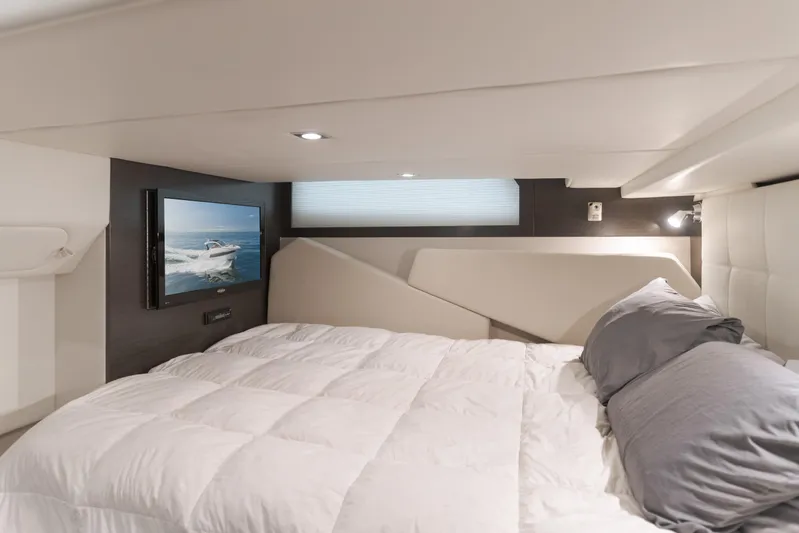 Lux Life Yacht Photos Pics Luxurious cabin interior of 2017 Cruisers Yachts 39 Express Coupe with TV and cozy bedding.
