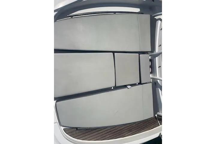  Yacht Photos Pics 2019 Jeanneau 9.0 WA boat deck with cushioned seating and wooden flooring.