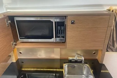  Yacht Photos Pics 2019 Jeanneau 9.0 WA boat kitchen with microwave and sink.