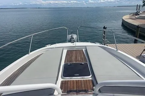  Yacht Photos Pics 2019 Jeanneau 9.0 WA boat docked, featuring spacious deck and scenic water view.