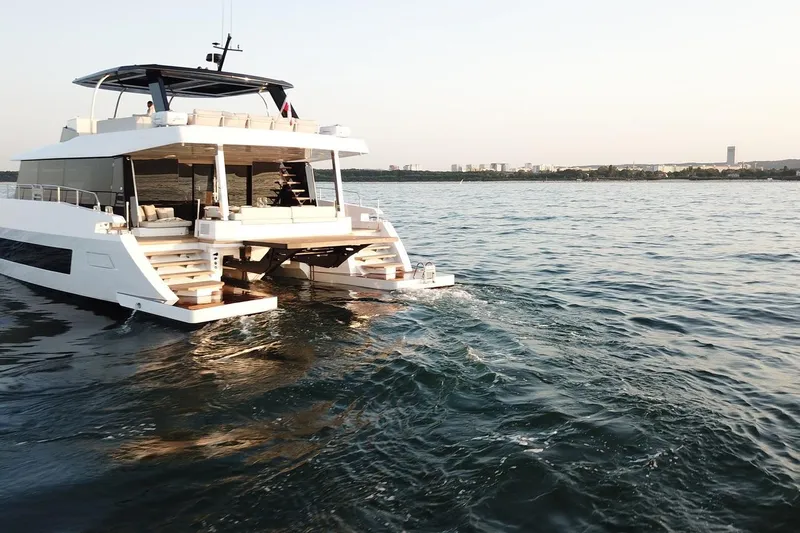  Yacht Photos Pics Luxurious 2026 Moon Yachts 6ty cruising on serene waters at sunset.