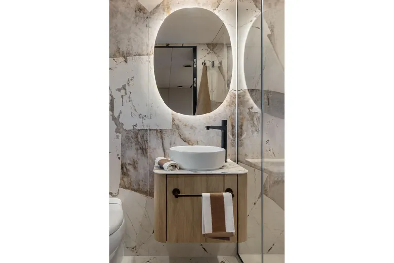  Yacht Photos Pics Luxurious bathroom in 2026 Moon Yachts 6ty, featuring modern sink and illuminated mirror.