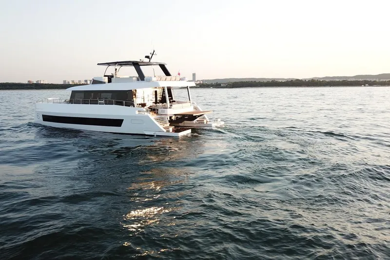  Yacht Photos Pics Luxury Moon Yachts 6ty 2026 cruising on serene ocean waters at sunset.