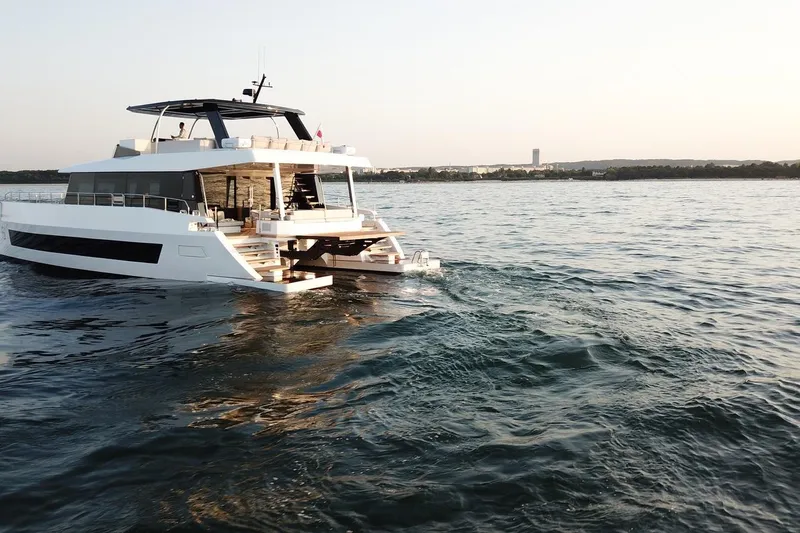  Yacht Photos Pics Luxury Moon Yachts 6ty 2026 cruising on serene waters at sunset.