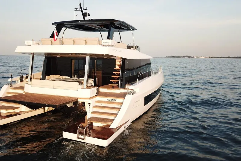  Yacht Photos Pics Luxurious 2026 Moon Yachts 6ty sailing on open water, showcasing elegant design and spacious deck.