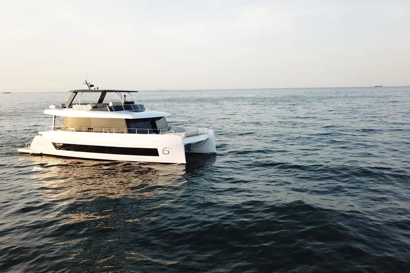  Yacht Photos Pics Luxury Moon Yachts 6ty 2026 model cruising on open sea at sunset.