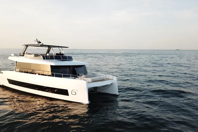  Yacht Photos Pics 2026 Moon Yachts 6ty luxury yacht cruising on open sea at sunset.