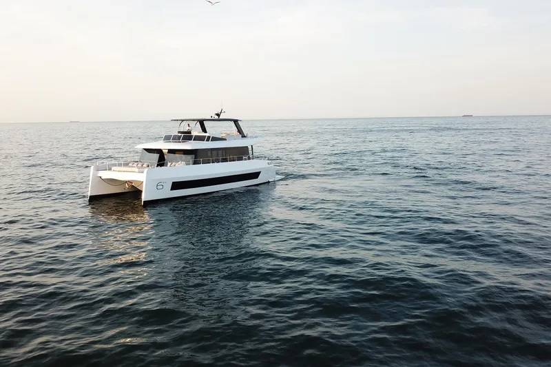  Yacht Photos Pics Luxury Moon Yachts 6ty 2026 model cruising on open sea under clear sky.