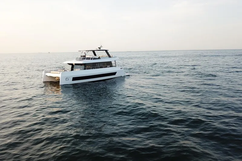  Yacht Photos Pics Luxury Moon Yachts 6ty 2026 model cruising on open sea at sunset.