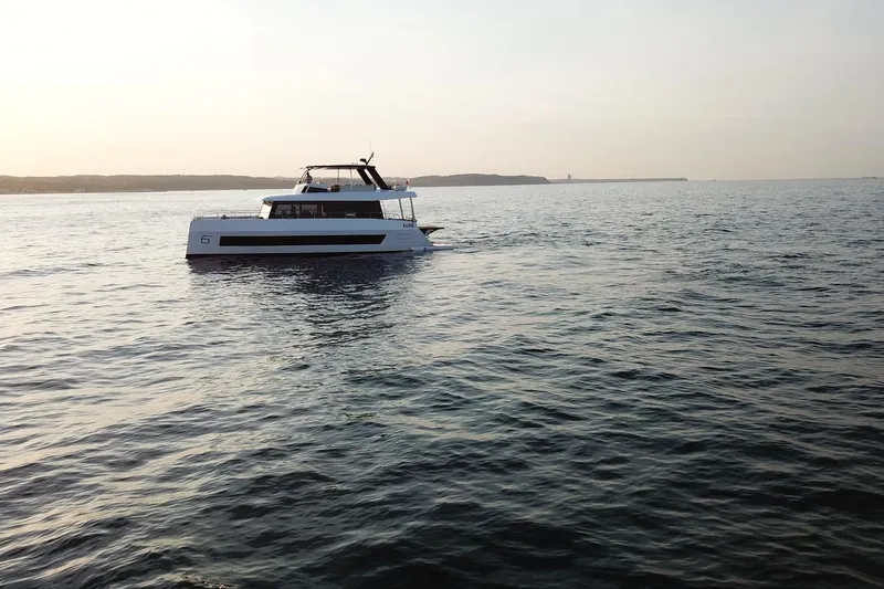  Yacht Photos Pics Moon Yachts 6ty 2026 sailing on calm sea at sunset.