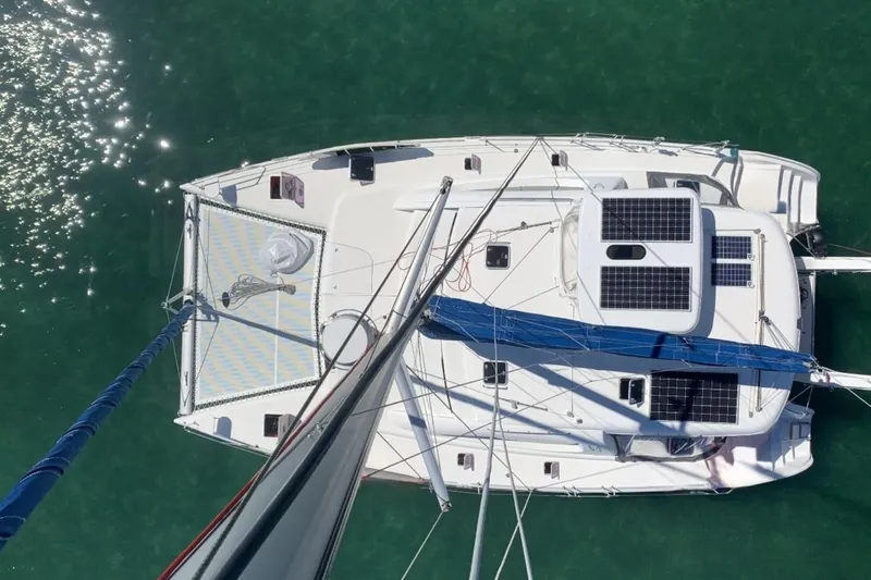 Mahi Mahi Yacht Photos Pics Aerial view of 2009 Leopard 46 catamaran with solar panels on turquoise water.