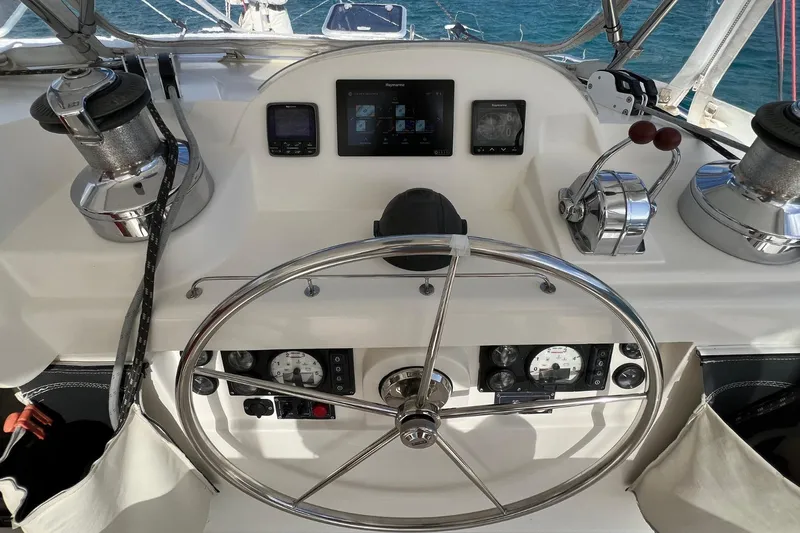 Mahi Mahi Yacht Photos Pics Steering wheel and controls of a 2009 Leopard 46 yacht, featuring navigation instruments.