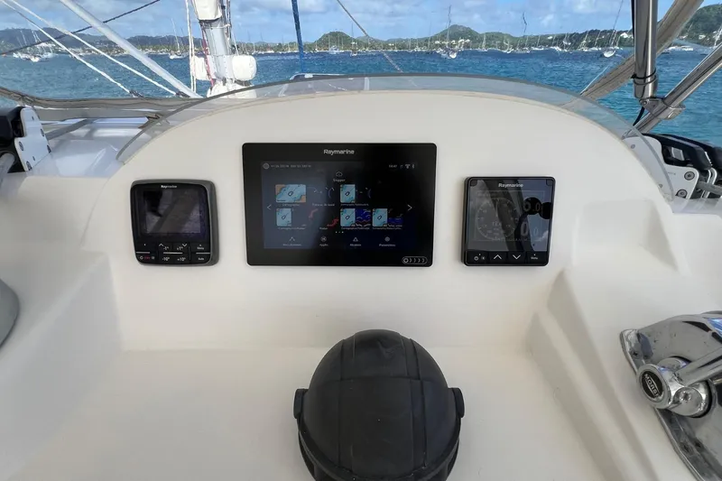 Mahi Mahi Yacht Photos Pics Helm of 2009 Leopard 46 yacht with Raymarine navigation displays, overlooking a scenic harbor.