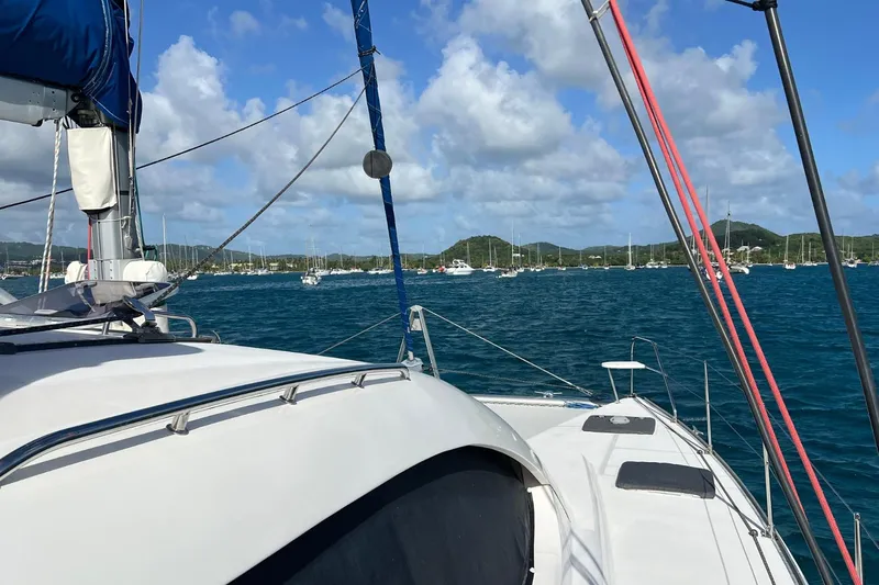 Mahi Mahi Yacht Photos Pics Sailing on a 2009 Leopard 46 yacht in a scenic bay with distant hills.