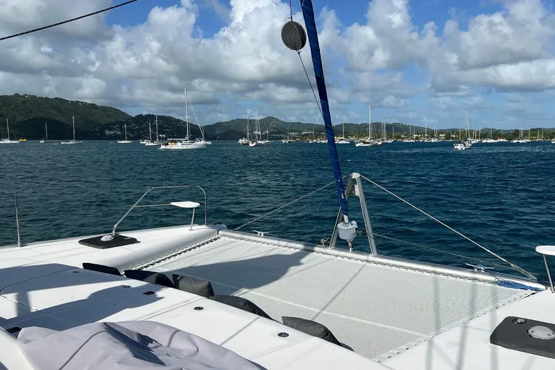 Mahi Mahi Yacht Photos Pics Sailing on a 2009 Leopard 46 catamaran in a scenic bay with distant sailboats.