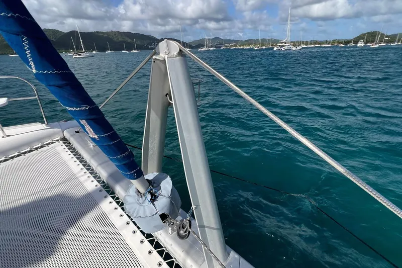 Mahi Mahi Yacht Photos Pics Sailing catamaran Leopard 46 on blue ocean, anchored near lush green hills, 2009 model.