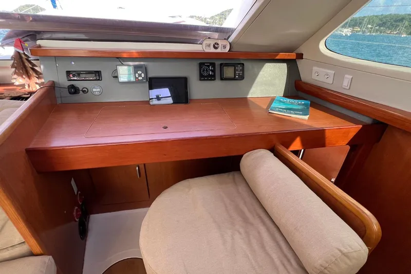 Mahi Mahi Yacht Photos Pics Navigation station on 2009 Leopard 46 yacht with control panel and book.