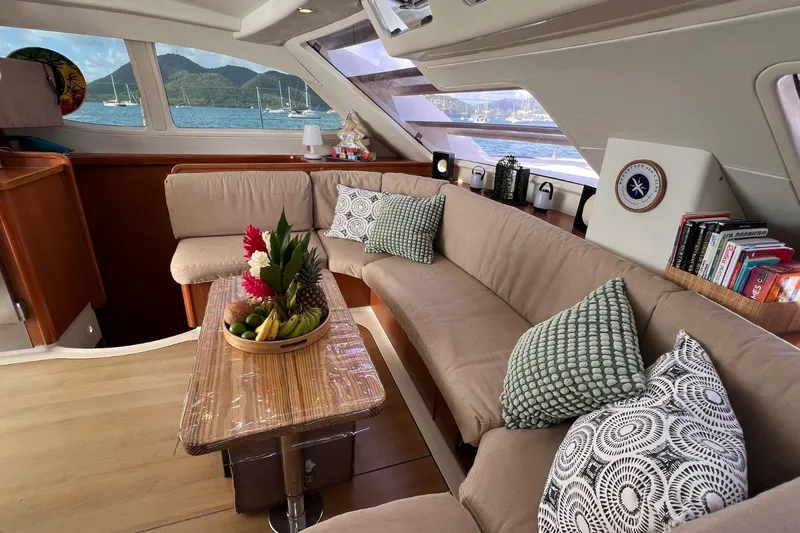 Mahi Mahi Yacht Photos Pics Luxurious 2009 Leopard 46 yacht interior with cozy seating, decorative pillows, and a fruit centerpiece.