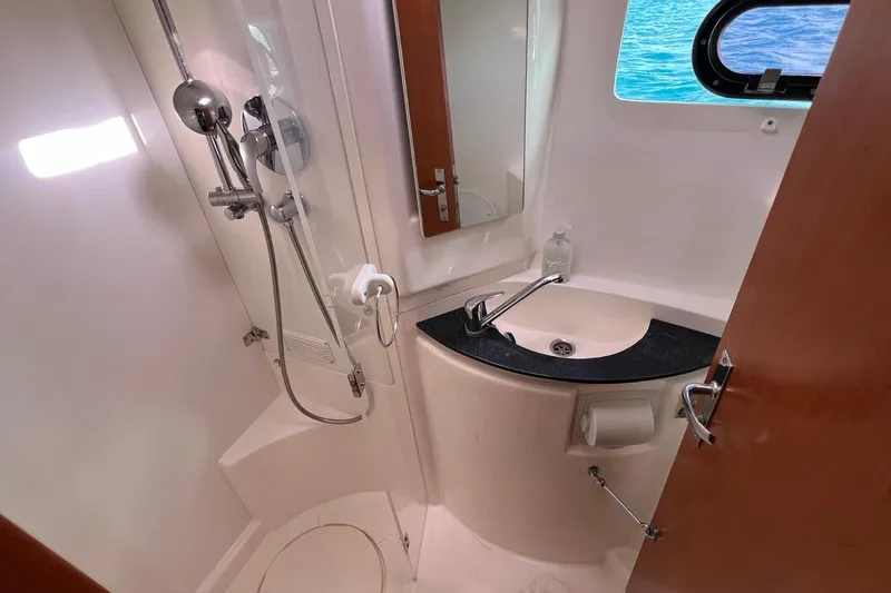 Mahi Mahi Yacht Photos Pics Bathroom interior of a 2009 Leopard 46 yacht with shower and sink.