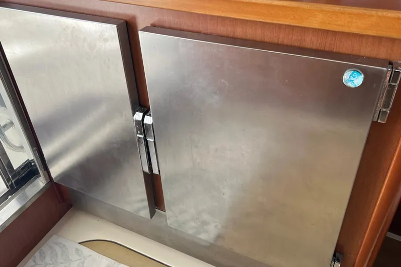 Mahi Mahi Yacht Photos Pics Stainless steel cabinet doors on a 2009 Leopard 46 yacht interior.