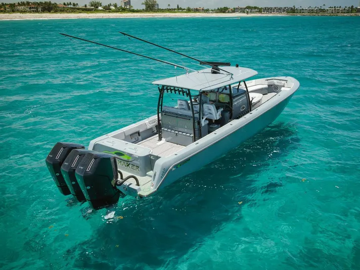 Deal Maker Yacht Photos Pics 2024 Contender 44ST boat cruising in clear blue waters.