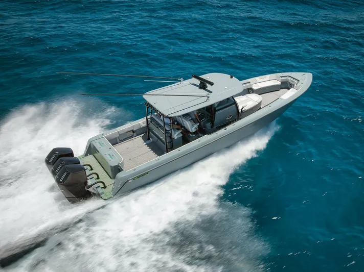 Deal Maker Yacht Photos Pics 2024 Contender 44ST boat cruising on blue ocean waters.