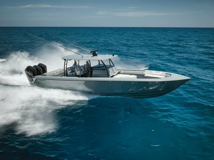 Deal Maker Yacht Photos Pics 2024 Contender 44ST boat speeding on the ocean.