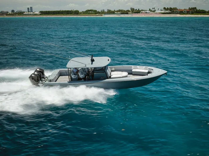 Deal Maker Yacht Photos Pics 2024 Contender 44ST boat cruising on clear blue water.