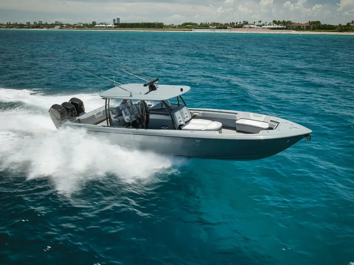 Deal Maker Yacht Photos Pics 2024 Contender 44ST boat speeding on the ocean.