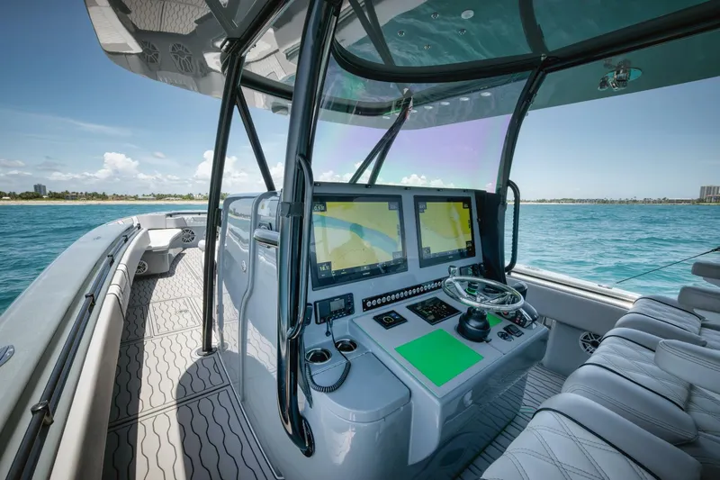 Deal Maker Yacht Photos Pics 2024 Contender 44ST boat cockpit with advanced navigation system and ocean view.